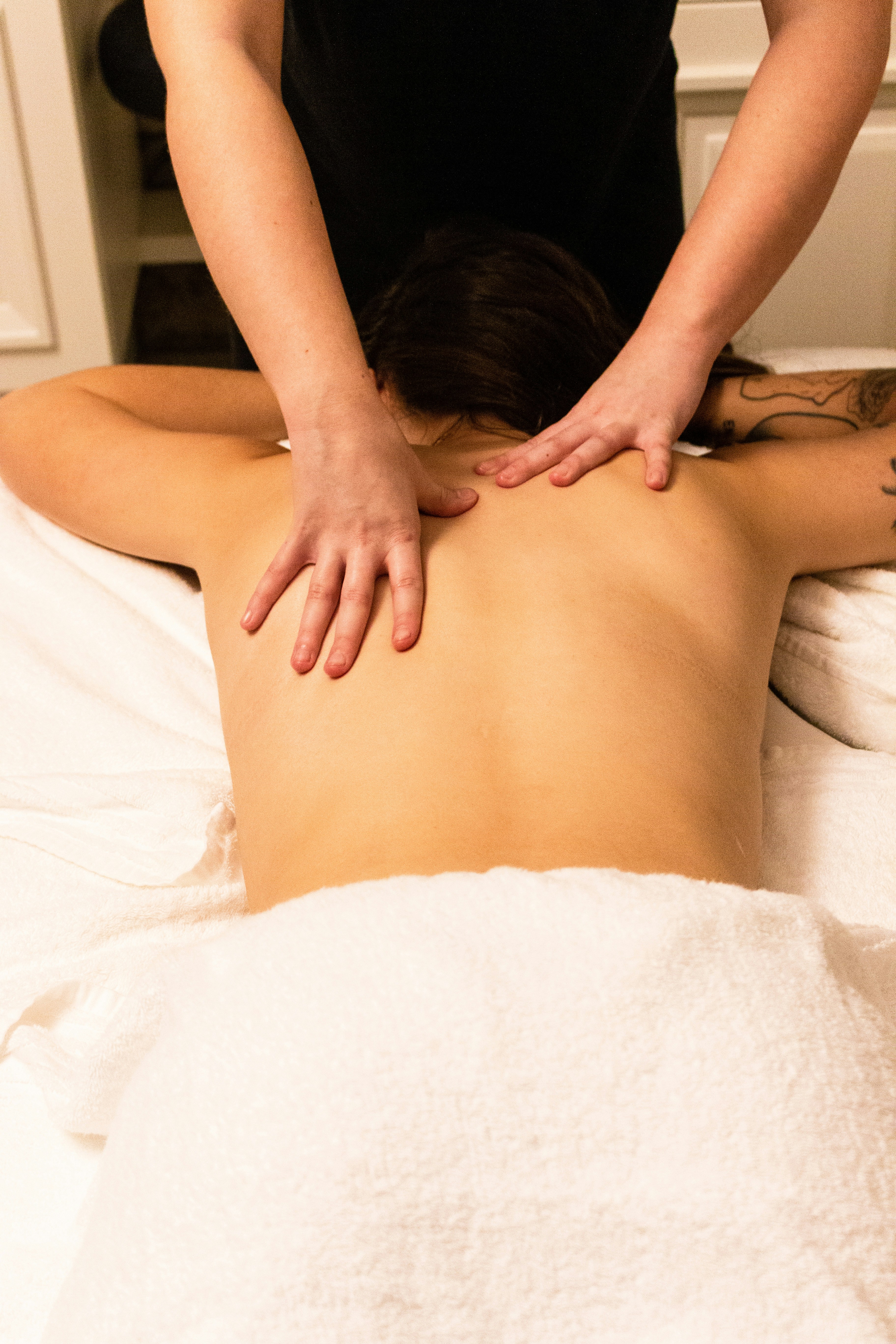 Therapist performing a back massage